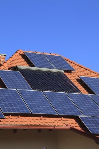 Alternative energy photovoltaic solar panels on tiled house roof